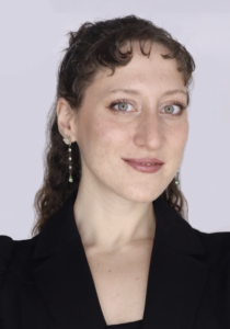 A woman smiling lightly. 